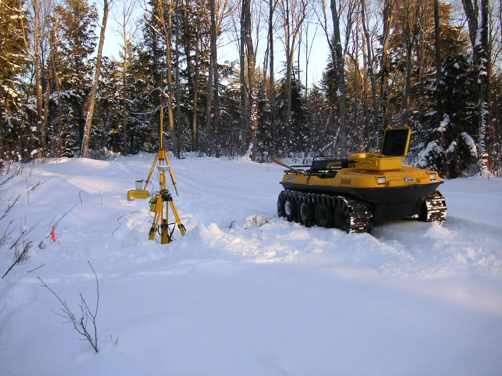 Survey equipment and an Argo vehicle at a remote winter field site