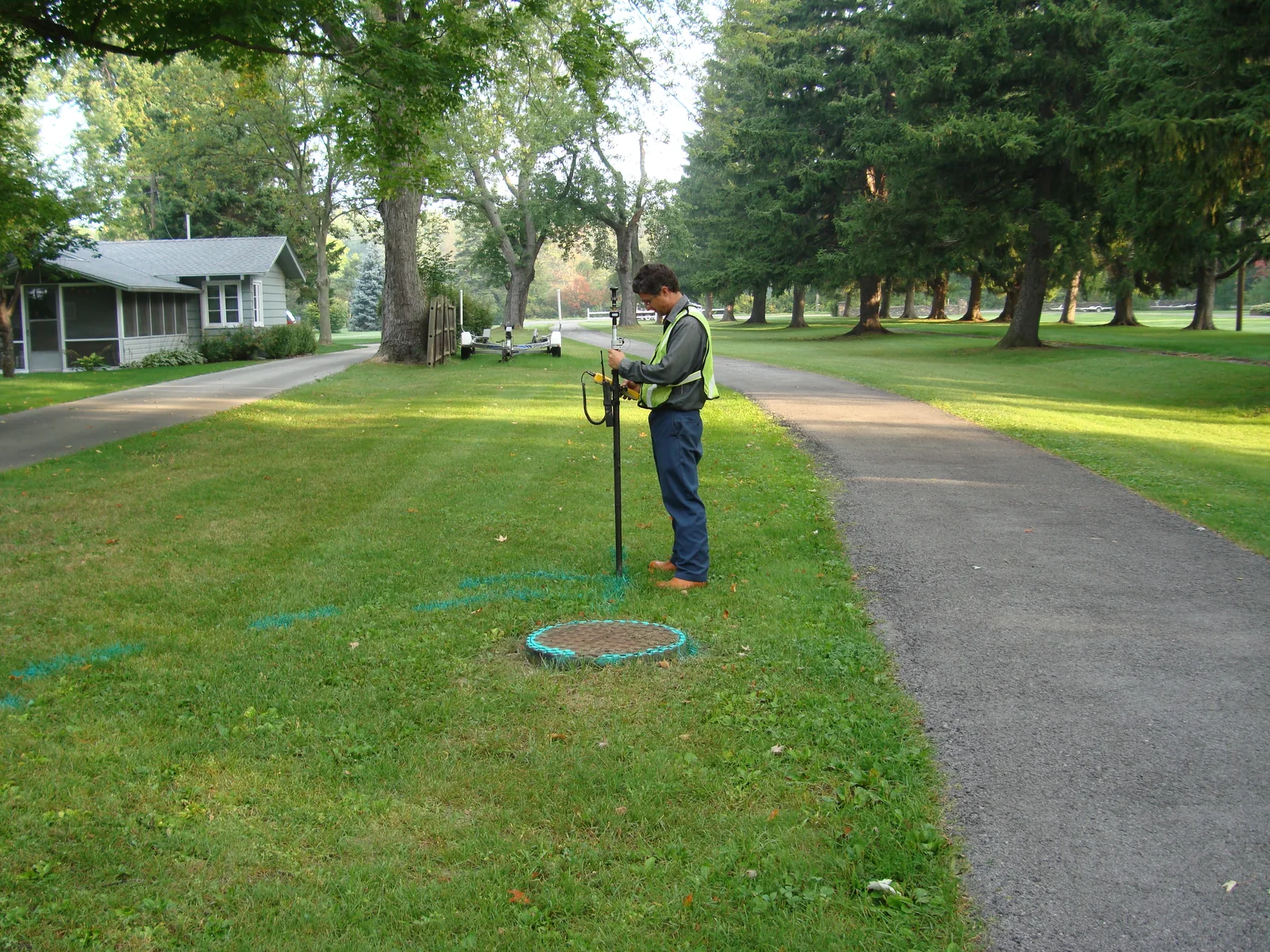 Surveyor collecting field measurements on a residential property
