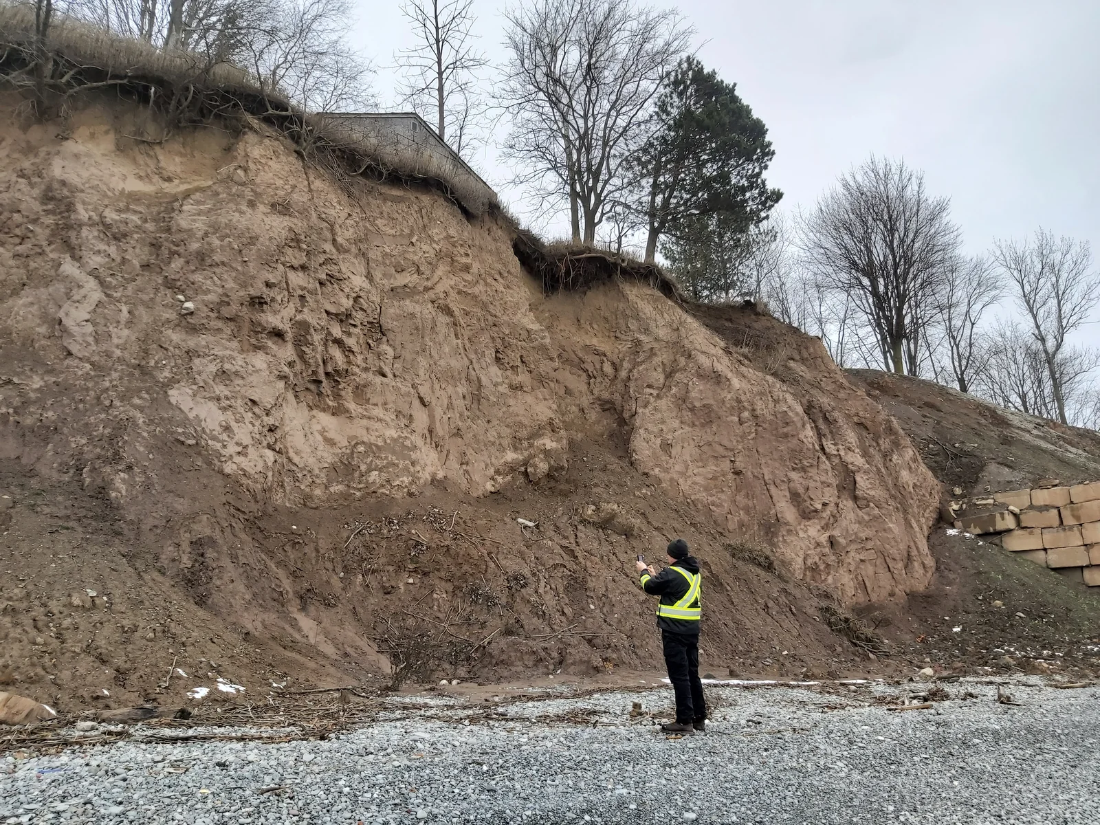 Surveyor documenting conditions at a steep site